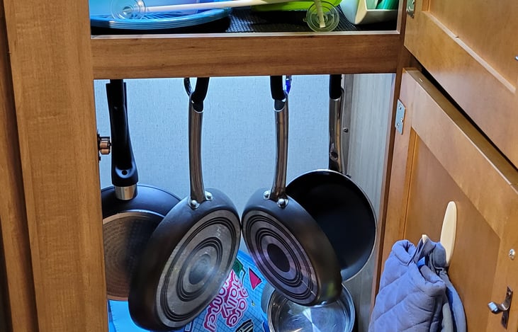 Cabinet where we have all the pots and pans located. You also see motion led lights that turn on when the cabinet opens.