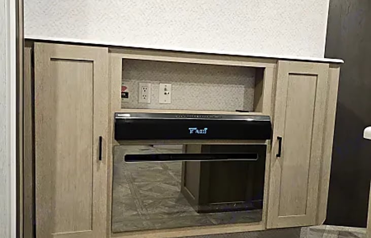 Entertainment system with fireplace and storage compartments.