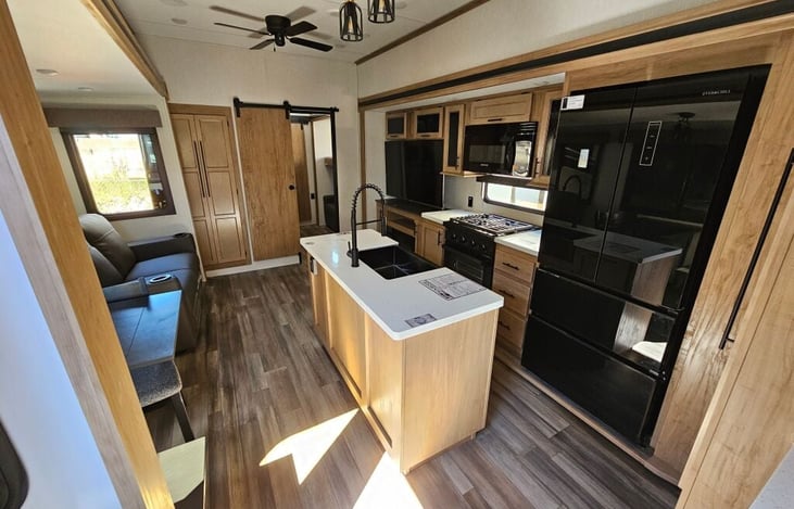 Kitchen, dining and living room. Includes smart tv, sofa/recliner, island sink, gas cooktop and oven, microwave, full-size refrigerator/freezer, pantry storage, dining table/chairs for 4 person