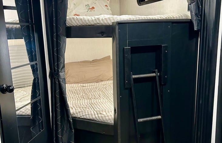 Bunk house with 2 full size beds, holds up to 450lbs each bed. And usb charging outlets in each as well as windows and lights.