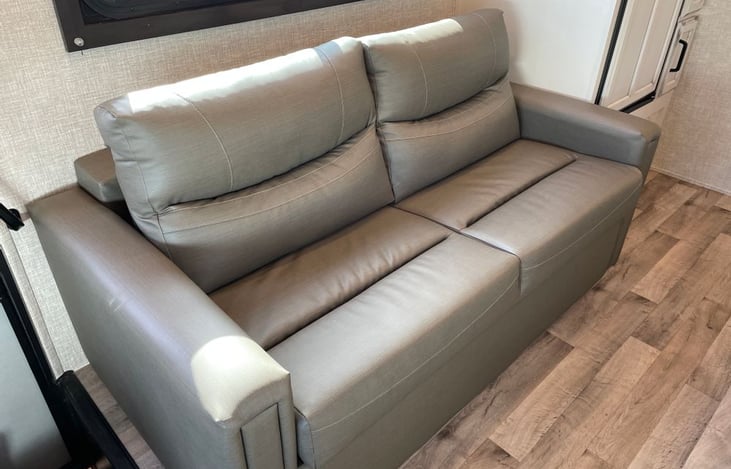 Coach with seatbelts that converts to double bed