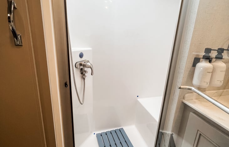 Spacious shower with premium fixtures for home-like comfort.