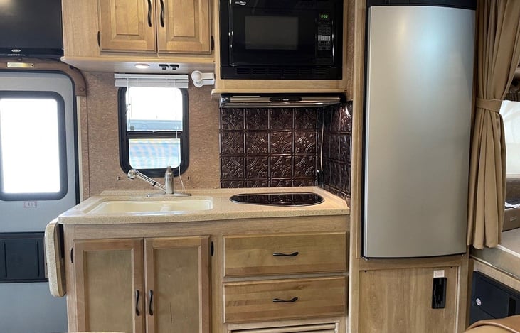 Functional kitchen and outdoor table with small Coleman grill.