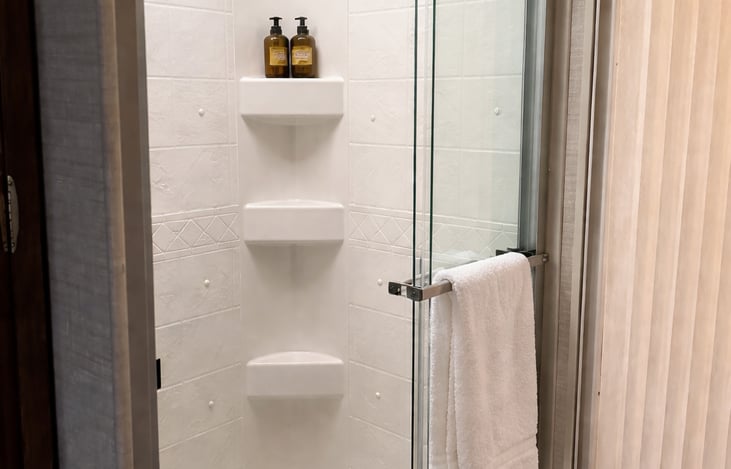 Full-size shower with glass door.