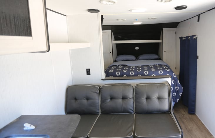 sofa with queen bed visible