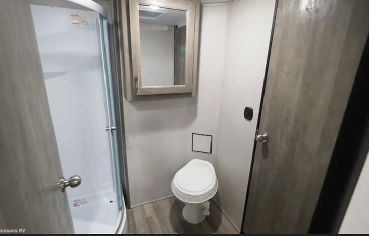 Full bathroom has ample room to access toilet and sink. Corner shower with sliding doors. Bathroom can be accessed from both hallway and master bedroom.