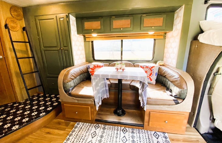 Spacious dinette with wrap-around seating — ideal for family RV rentals and cozy meals on the go.