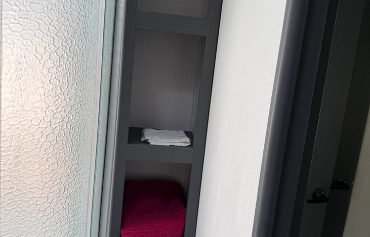 Plenty of towel storage next to shower