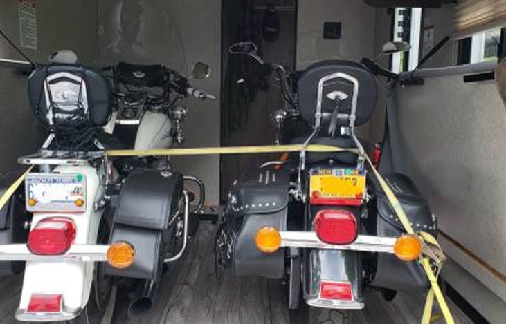 Benches fold up against the walls to allow full access to garage. There are 6 "D" Rings in the floor to secure your toys!.