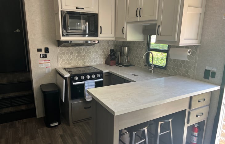 Full size residential fridge on opposite side of kitchen too.