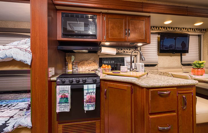 Kitchen with 3-burner range and oven.