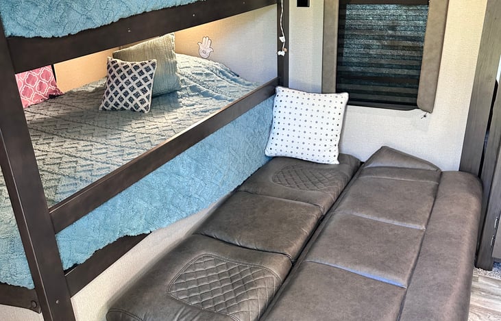 Fold out couch into a bed. For some reason our 12 year old prefers this over the bunks. Sheets and extra pillows in cabinet next to bunks.