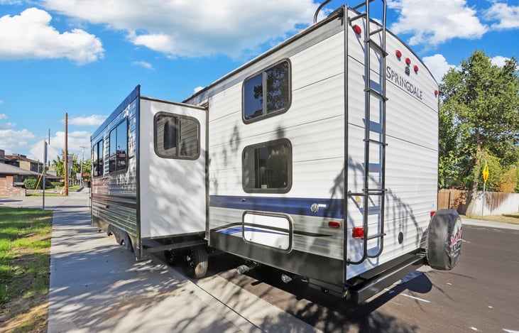 One slide out. You can see the door for storage. We keep the dump hoses and brake chocks here.