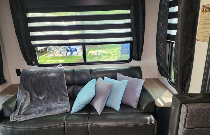 Every detail is presented in a comfy cozy way!  This is the couch before it is turned into a bed.