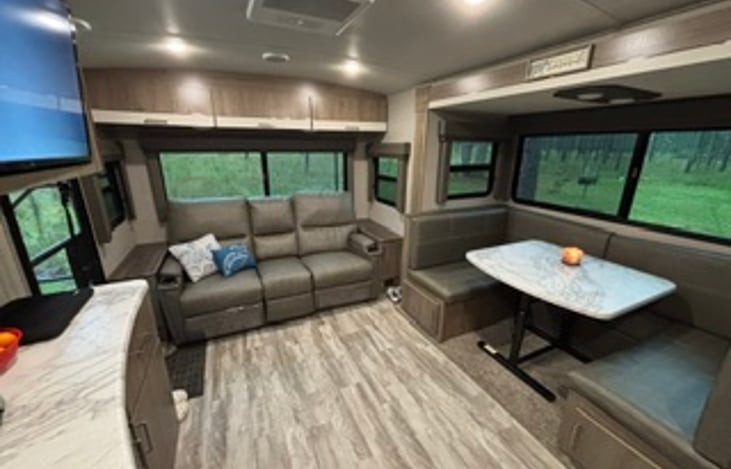 Couch has heated, vibrating and lighted seating with two recliners. Table area folds down into another sleeping area if needed.