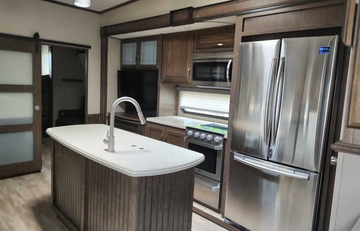 Beautiful kitchen with island and residential size stainless fridge