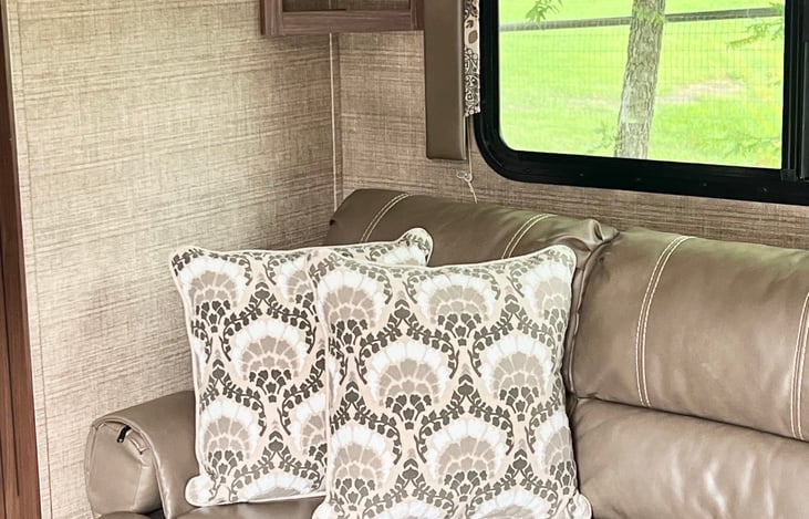 Relax on the couch while enjoying the views from the camper