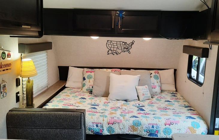 Queen bed, extra pillows for a daytime lounge area. Overhead storage and DVD player.