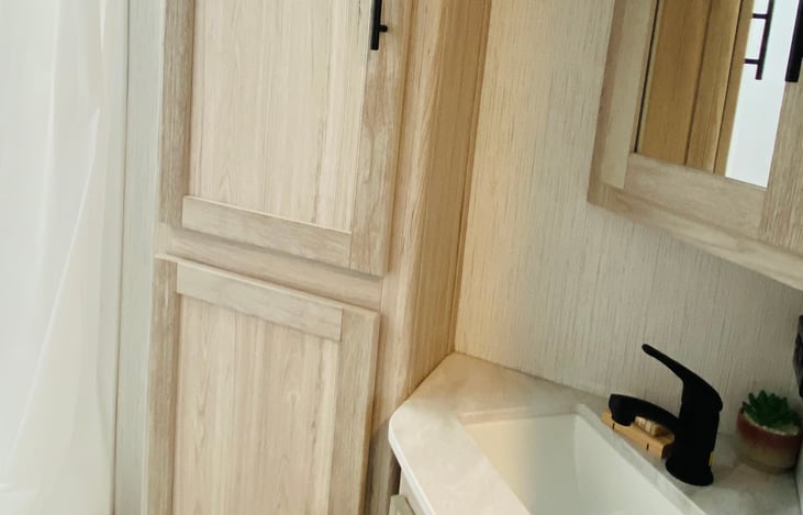 large cabinets for plenty of storage in bathroom.