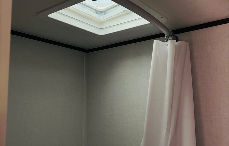 Shower with rounded shower rod.