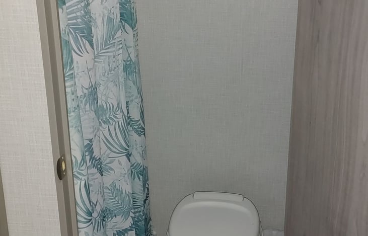 Shower and toilet. RV paper included.