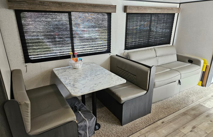 Extra bedding and pillows are placed in the dining room seating