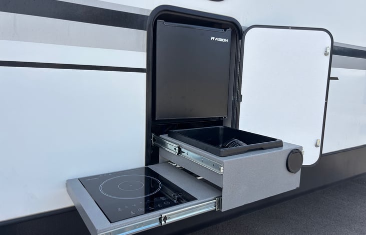 Outdoor kitchen. Mini fridge, sink, and stove top.