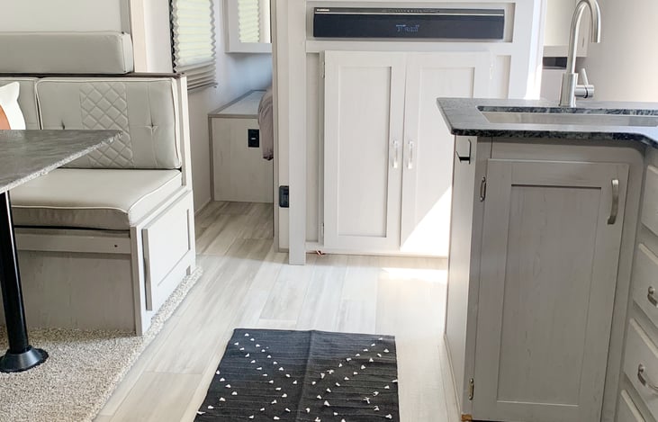 The slideout provides a open space in the kitchen and dining area. A television is available along with inside and outside speakers for jamming to music.