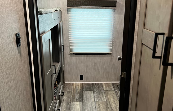 Bunk room with three bunks including couch/queen bed