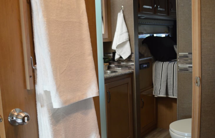 Bathroom with tons of storage and hooks to hang towels.