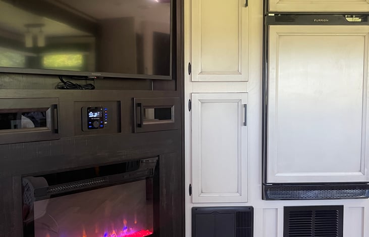 TV, fireplace, refrigerator and freezer with food pantry.