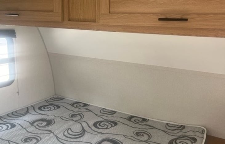 Queen size bed with overhead storage.