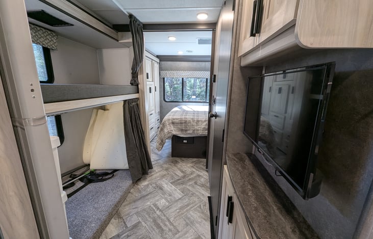Hallway and "kids-zone" bunkhouse with TV and storage.