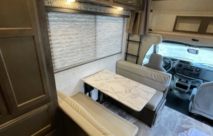 Dinette can convert into sleeping area. Also features 4 buckles.