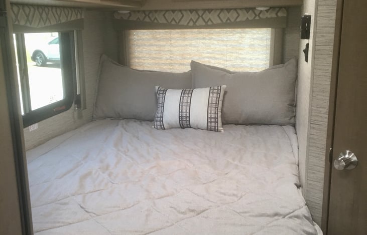 This Queen size bed has a retractable privacy shade
Overhead lighting, there are rear and side windows for the views of your surroundings (pull down shades offer privacy and shade when needed)