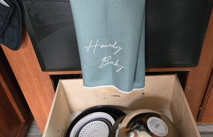 Motorhome comes stocked with basic cooking essentials, cups, plates, bowls, and silverware.