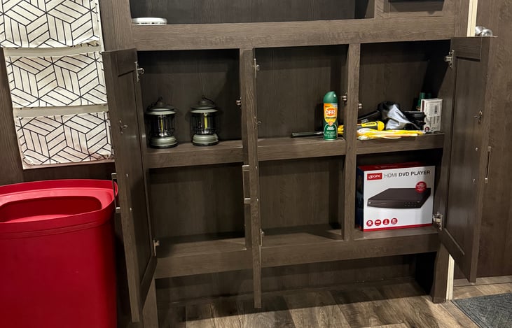 Entertainment center storage includes three doors with two shelves each.