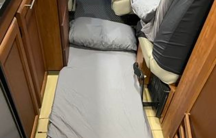 Foam folding mattress for a child on the floor. Also a platform bed for another child that goes across the front passenger  and 3rd seat behind it, making it accomodate 2 adults & 3 small children