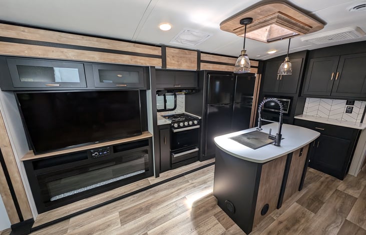 Very spacious kitchen with gas stove, oven, microwave, double-fridges, island with sky light, ample storage, and more.