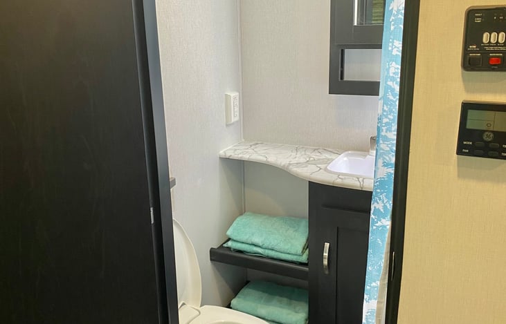 Shower has detachable head on it, all bathroom amenities included, even towels!