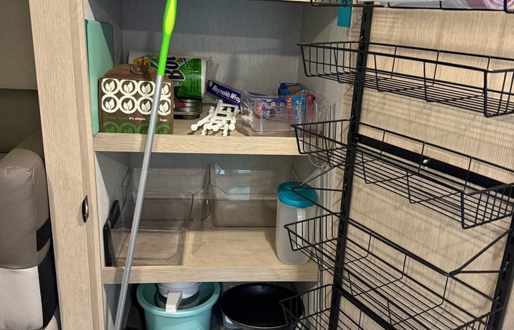 Pantry with shelves, cookware and supplies
