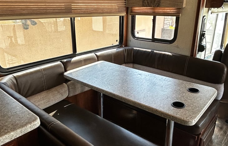 Spacious dining table with 2 cup holders. Fully accessible while driving.