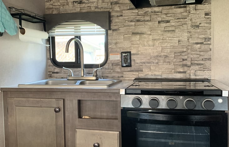 Adorable small kitchen with everything you need to cook delicious meals.