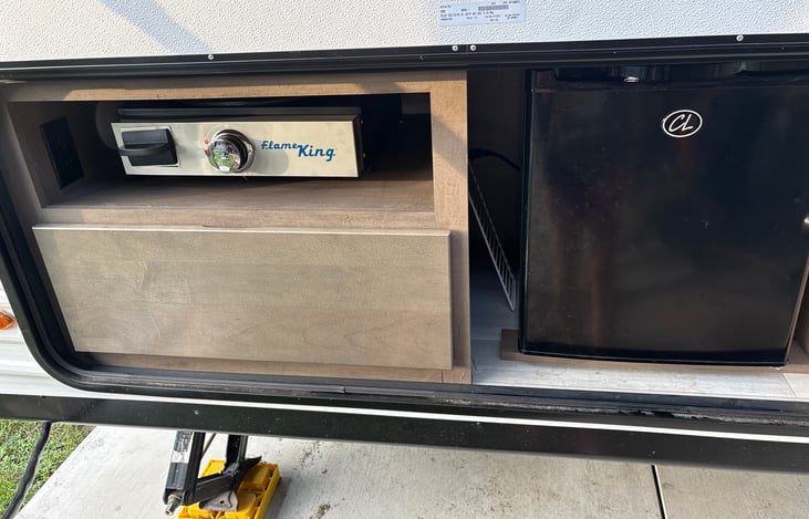 Outside fridge and griddle.