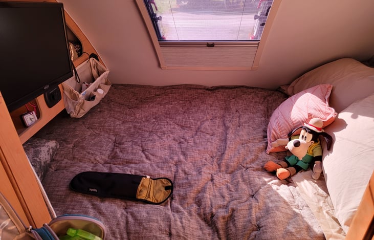 Queen bed under stargazer window