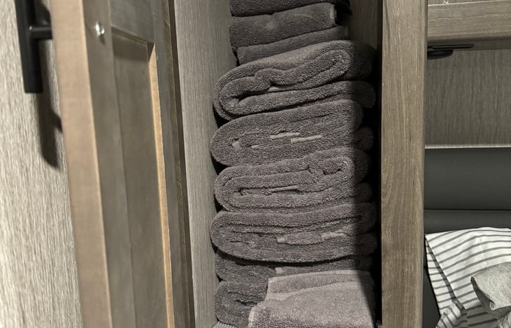 Side cabinet in back bedroom. RV comes with 6 towels, 4 hand towels and wash cloths.
