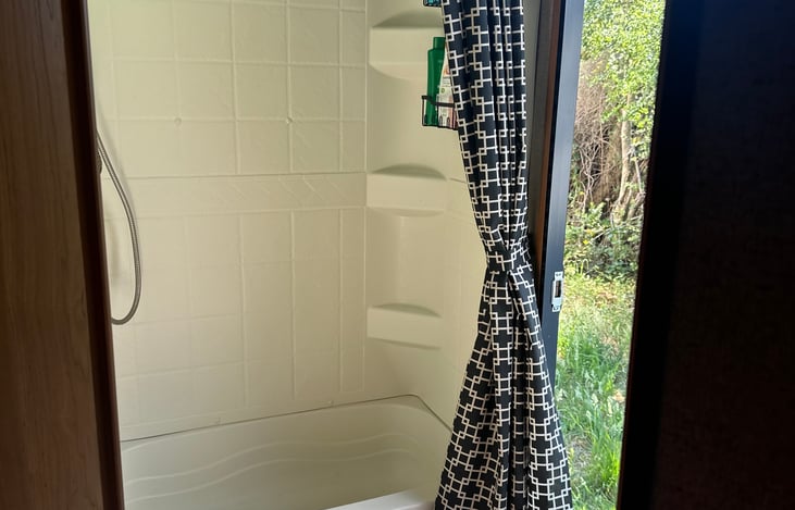 There is a toilet on the left and a sink on the right. Picture won't turn. The door that opens up to outside.