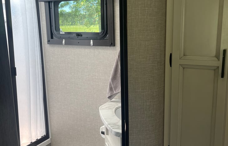 Walk in shower. Toilet. Sink. 2 rolls of camper safe toilet tissue provided.