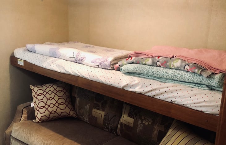 twin bunk up top and full size pull out couch below, all linens/blankets are provided