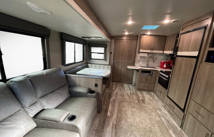 2 person couch, dinning area, kitchen area, fridge, mini Ice maker.